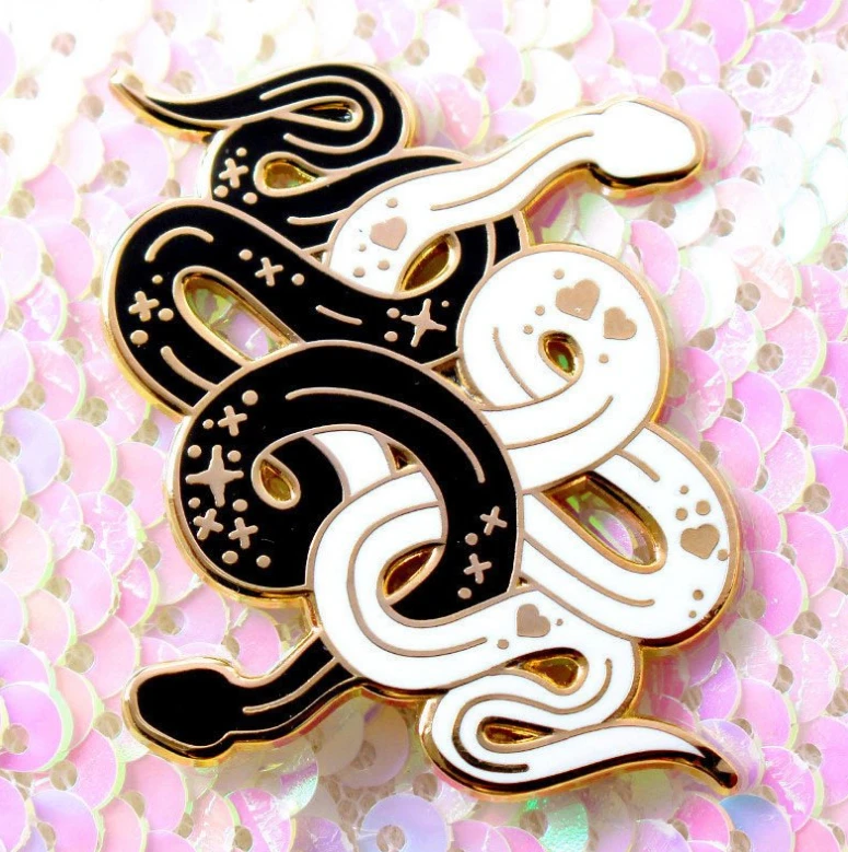Black and white snake enamel pin